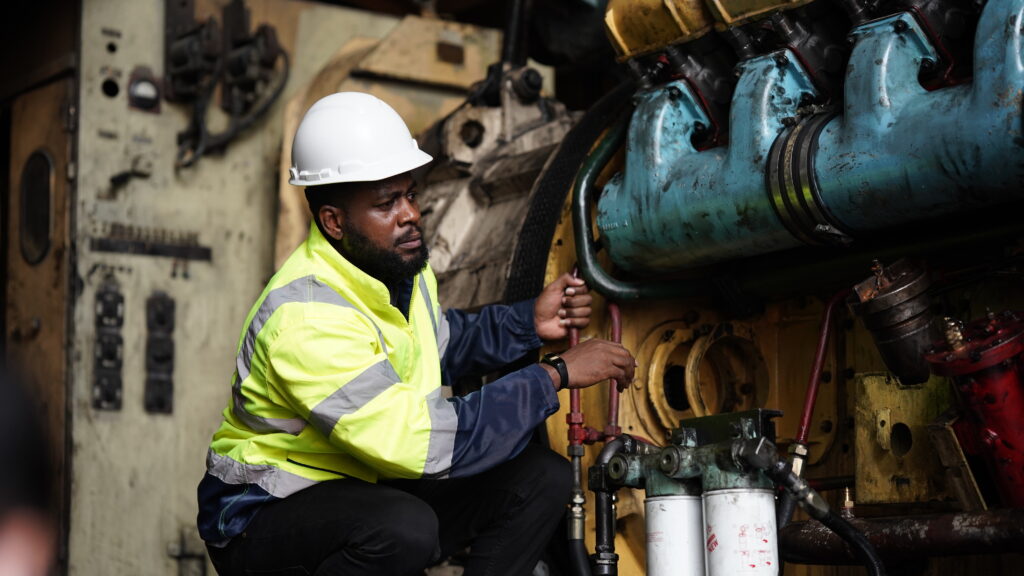 Workforce Management in Mining: Control Across Complex Shifts 1 Miner fixing mining equipment.