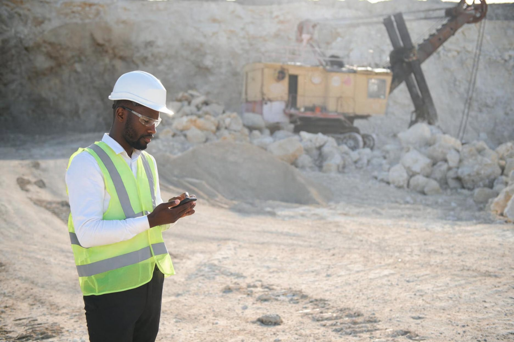 Field supervisor uses a mobile device to coordinate workforce information at a mining site.